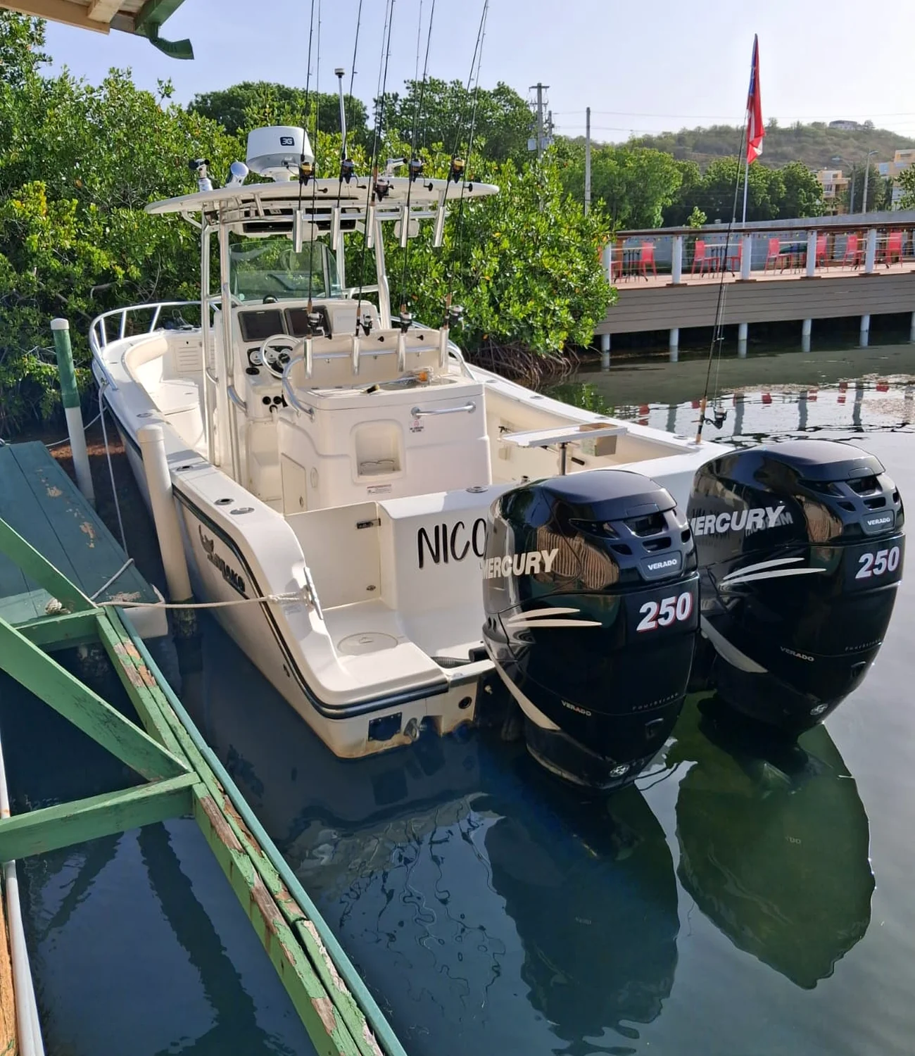 Twin-engine center-console fishing boat at the dock